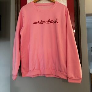 'overstimulated.' Pink Crewneck Sweatshirt